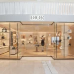 Dior luxury boutique storefront displaying handbags and accessories inside a modern shopping mall – Dior 2026 collection showcase