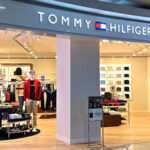 "Tommy Hilfiger store interior with clothing displays."