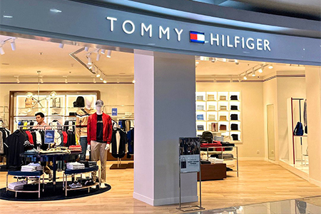 "Tommy Hilfiger store interior with clothing displays."